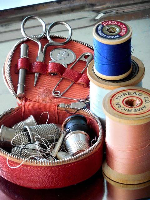textile studio worktable with fabric scissors pins thread and sewing machine